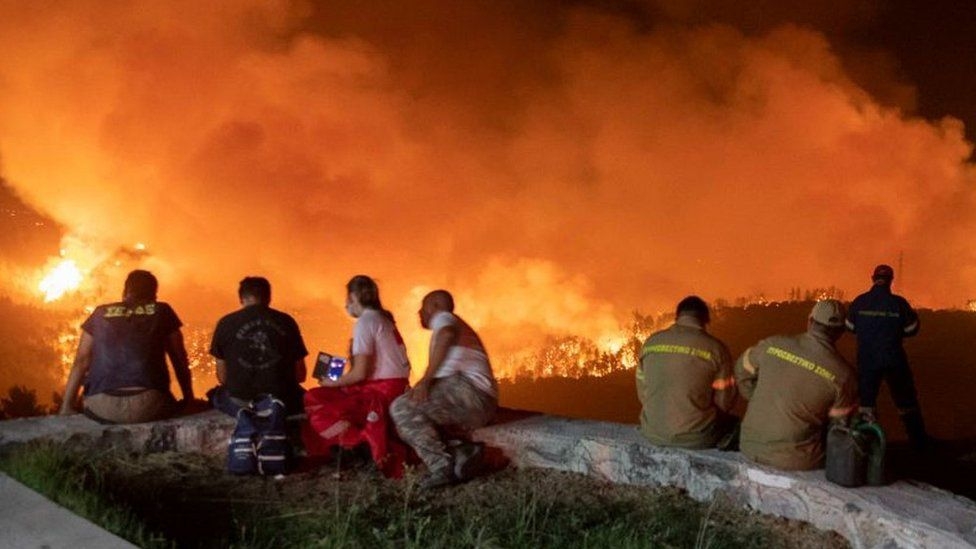 Greece battles deadly wildfires near Athens and on Evia island